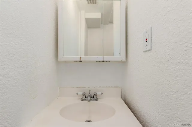 a bathroom with a sink and cabinets