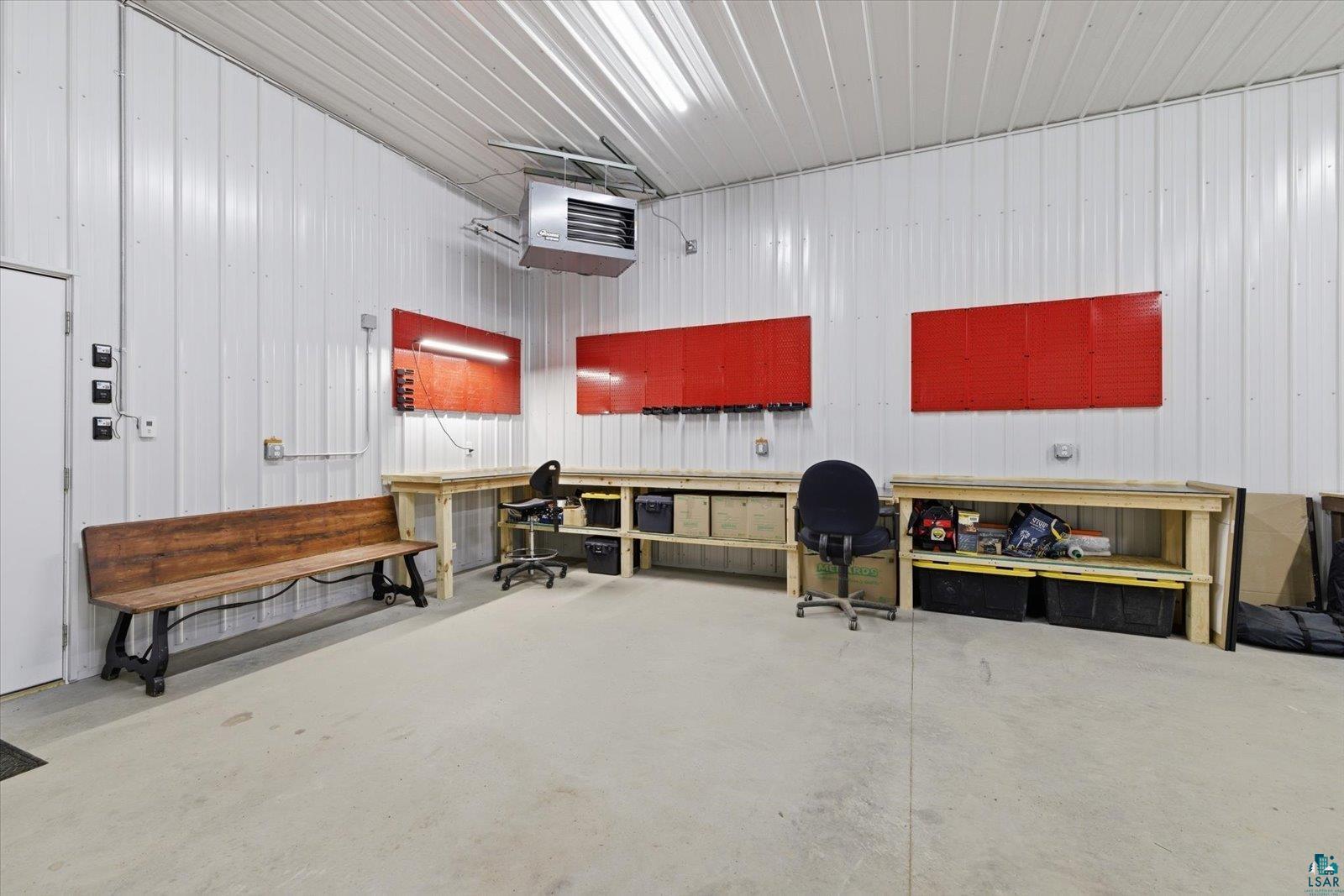 7185 Giants Ridge Road Embarrass, MN 55732 - Photo 44 of 47 Spacious workshop featuring concrete flooring, white metal panel walls, and bright overhead strip lighting