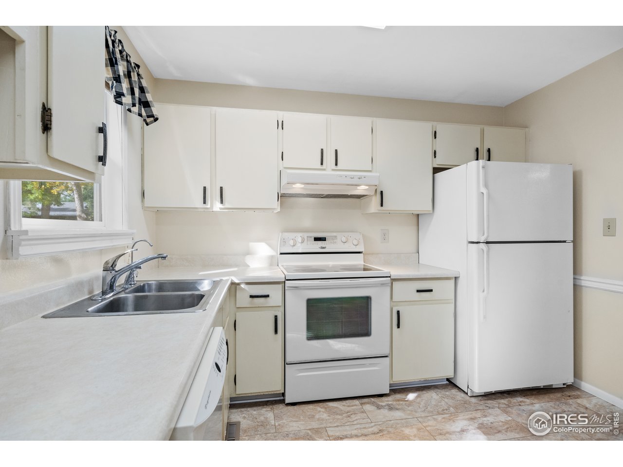3507 Post Road Laporte, CO 80535 - Photo 3 of 40 The sweet kitchen has soft colored walls and laminate counters and white appliances.