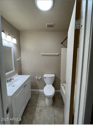 a bathroom with a toilet sink and a mirror