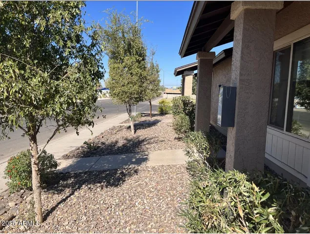 a pathway of a house with a yard