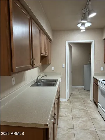 a kitchen with a sink a stove and cabinets
