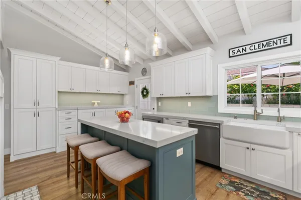 a kitchen that has a sink and a stove in it