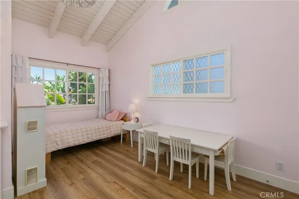 a bedroom with furniture and a wooden floor