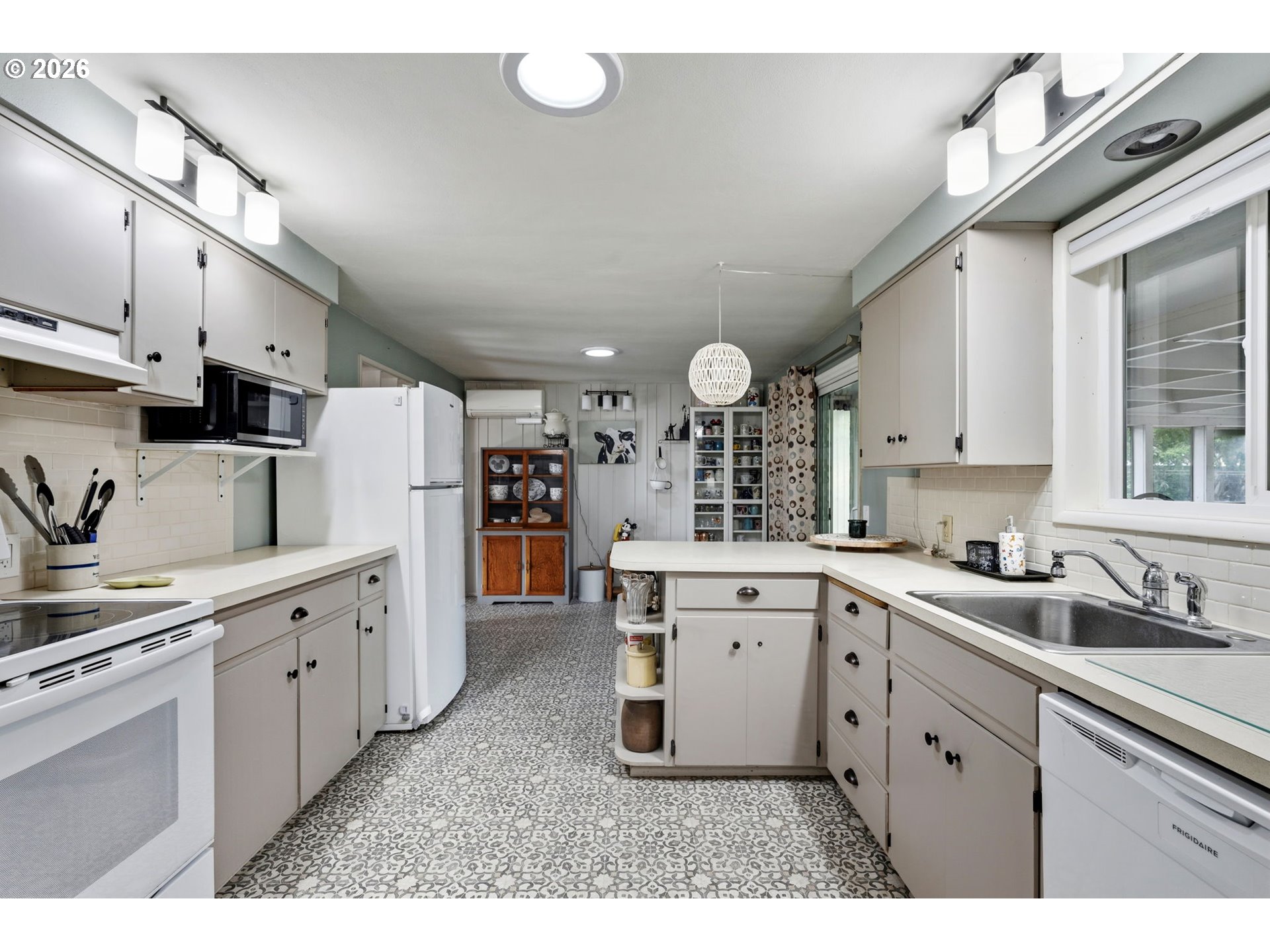 2936 Game Farm Road Springfield, OR 97477 - Photo 9 of 25 a kitchen with white cabinets a sink stove and refrigerator