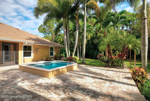 a view of a backyard with swimming pool