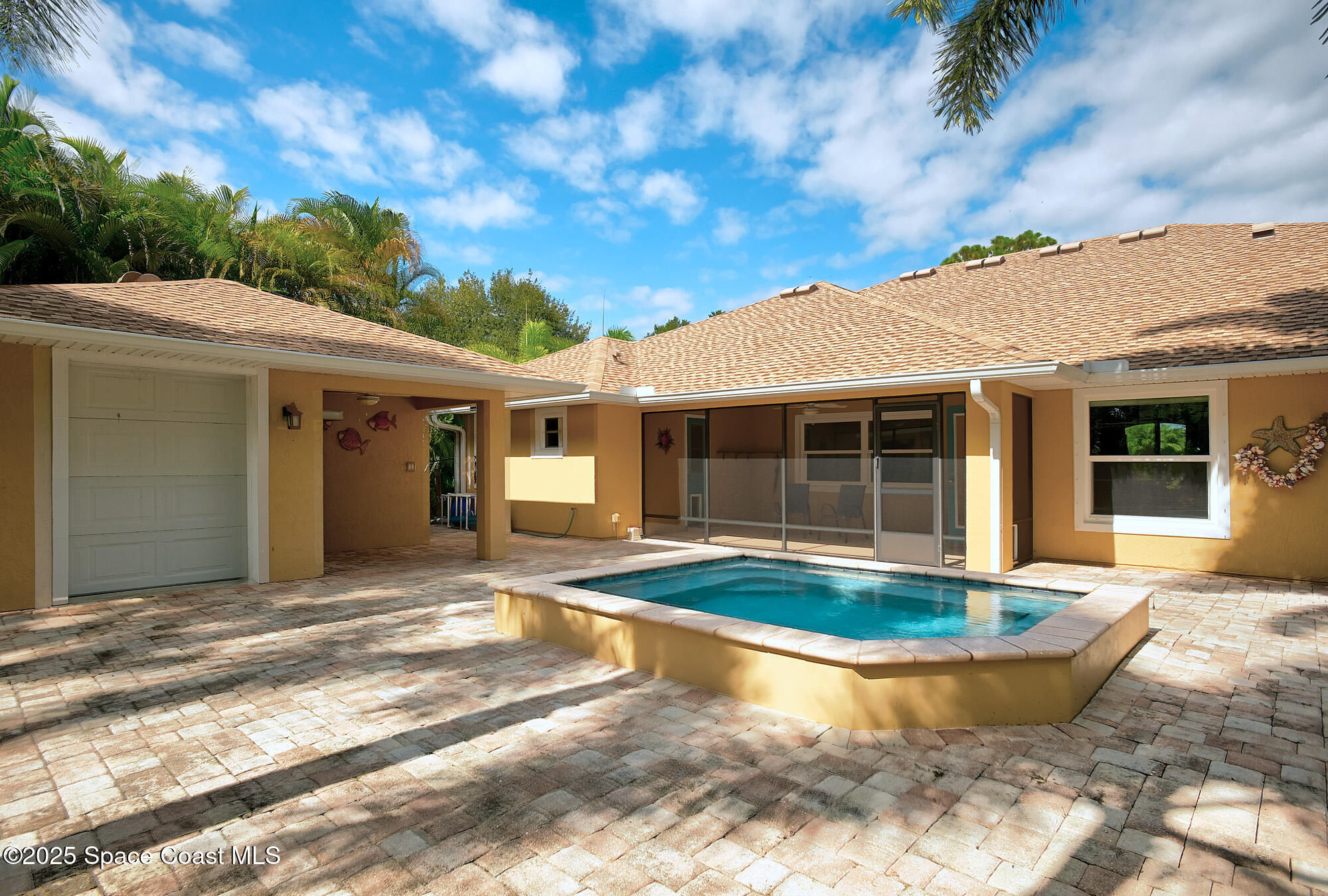 4580 Hunters Run Circle Grant, FL 32949 - Photo 12 of 55 a view of a white house with a large pool and large tree