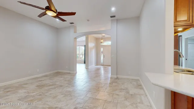 a kitchen with stainless steel appliances granite countertop a sink refrigerator and cabinets