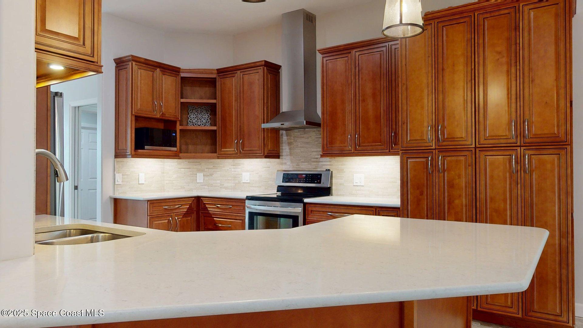 4580 Hunters Run Circle Grant, FL 32949 - Photo 27 of 55 a large kitchen with stainless steel appliances a refrigerator and a stove top oven