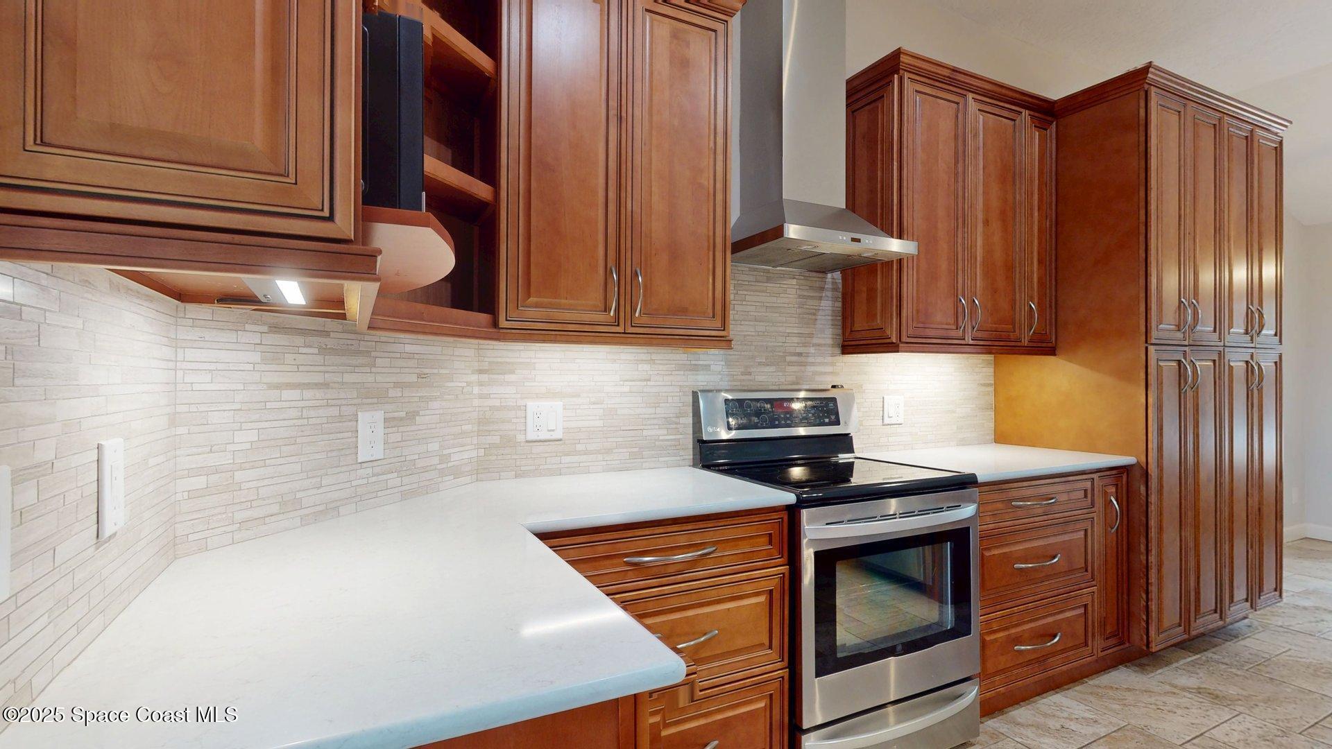 4580 Hunters Run Circle Grant, FL 32949 - Photo 30 of 55 a kitchen with stainless steel appliances granite countertop a stove a sink and a microwave