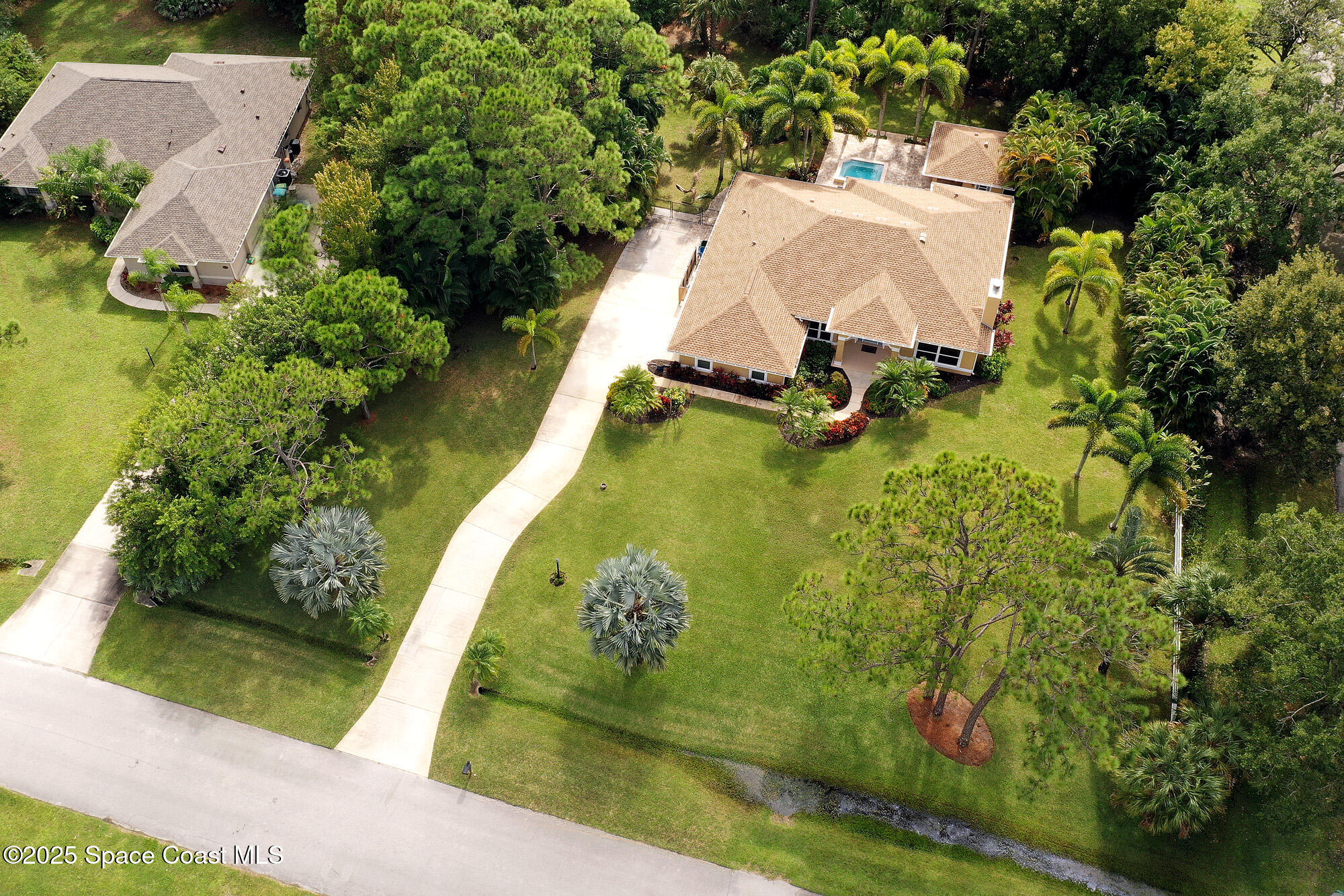 4580 Hunters Run Circle Grant, FL 32949 - Photo 3 of 55 an aerial view of a house with a yard and lake view