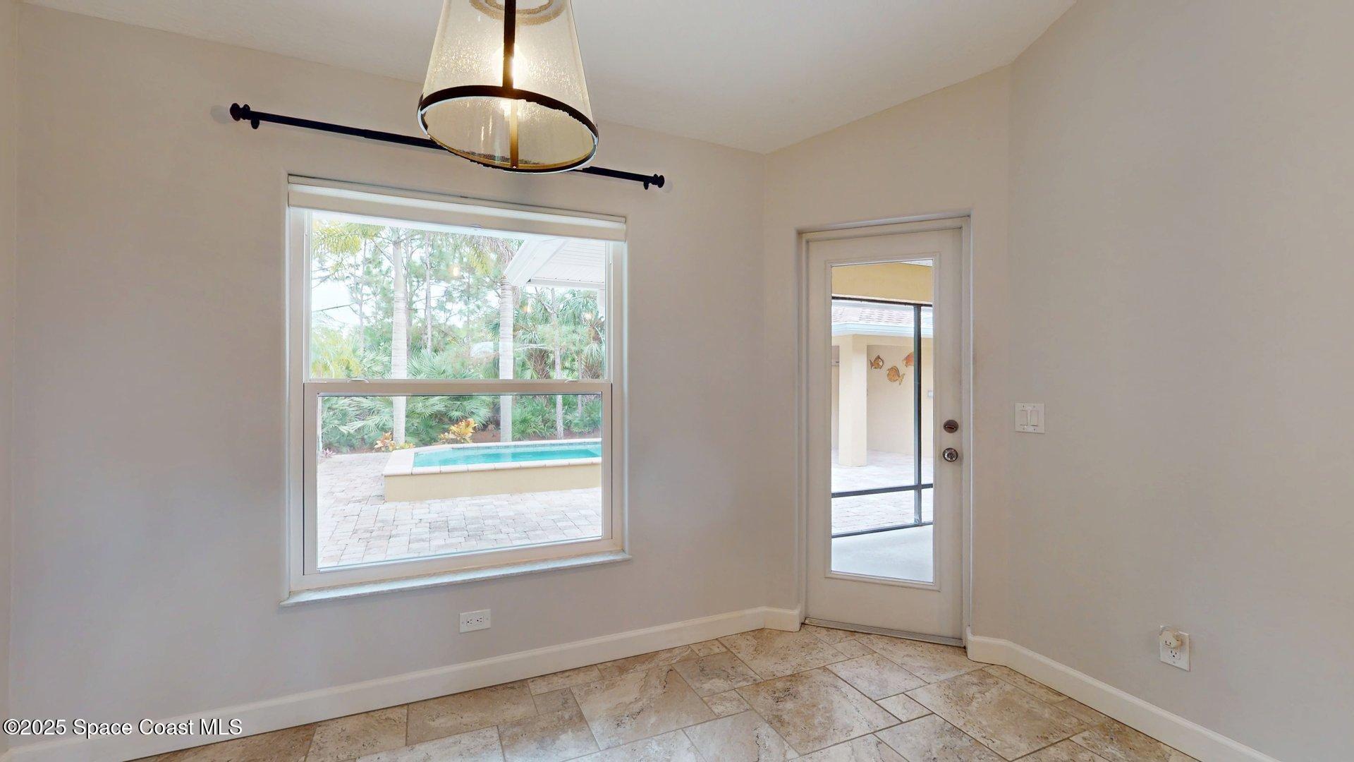 4580 Hunters Run Circle Grant, FL 32949 - Photo 32 of 55 a view of an empty room with wooden floor and a window