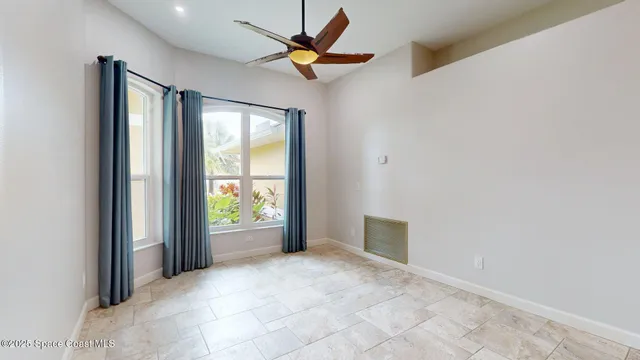 an empty room with a cabinet and mirrors