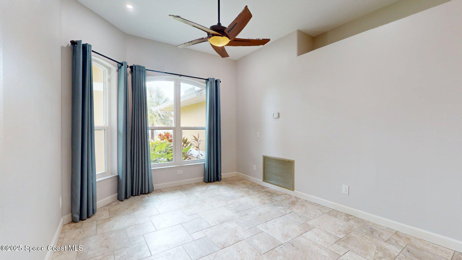 4580 Hunters Run Circle Grant, FL 32949 - Photo 34 of 55 a view of an empty room and a ceiling fan and window