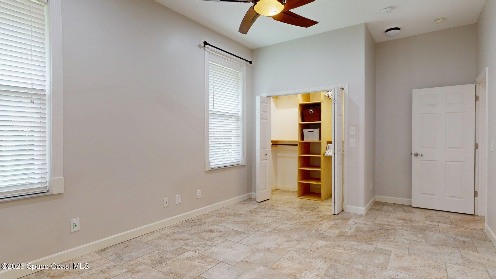 4580 Hunters Run Circle Grant, FL 32949 - Photo 42 of 55 an empty room with a window and ceiling fan