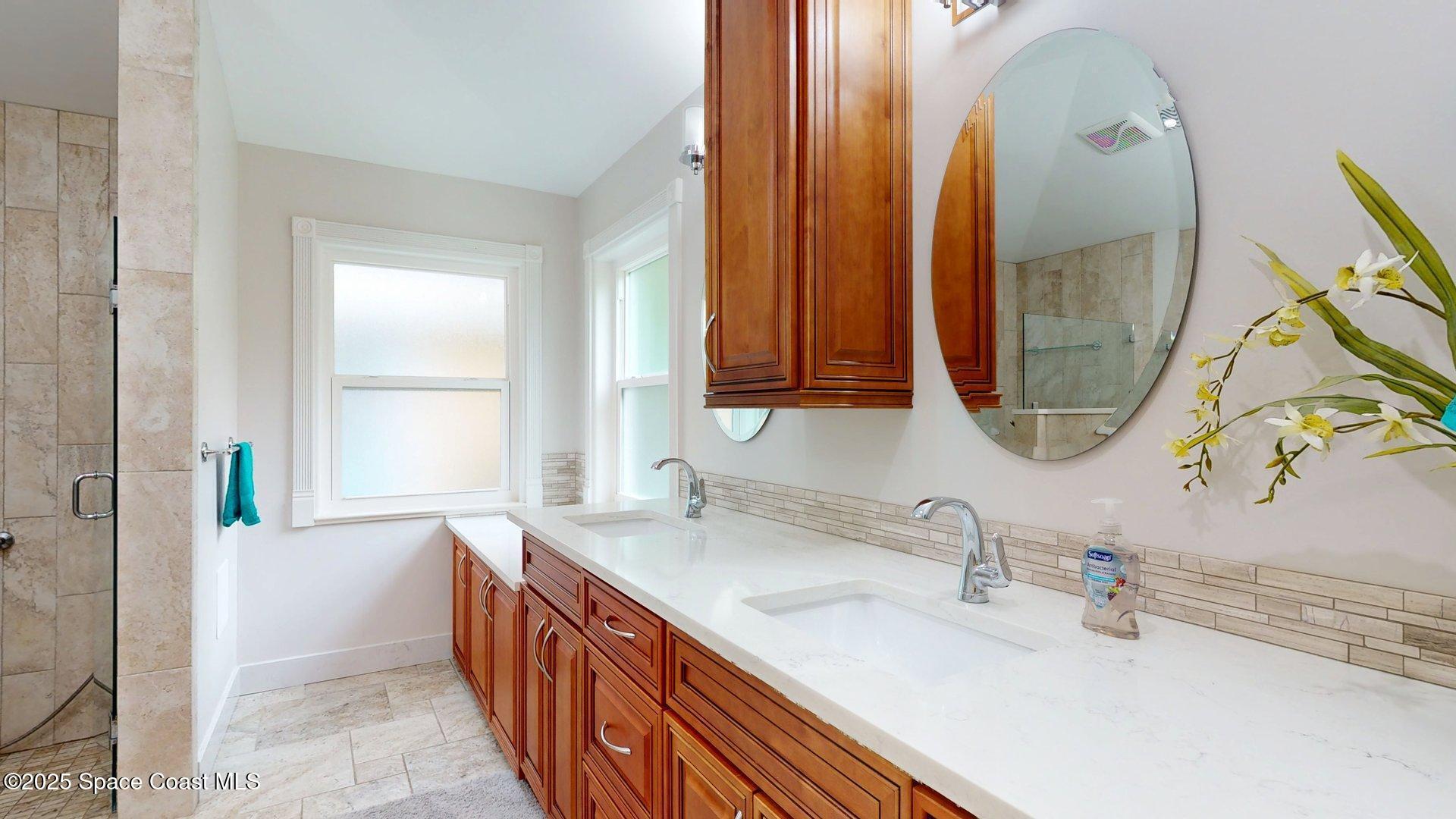4580 Hunters Run Circle Grant, FL 32949 - Photo 43 of 55 a bathroom with a double vanity sink and a mirror