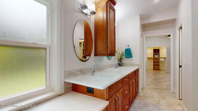 a bathroom with a granite countertop toilet a sink and shower