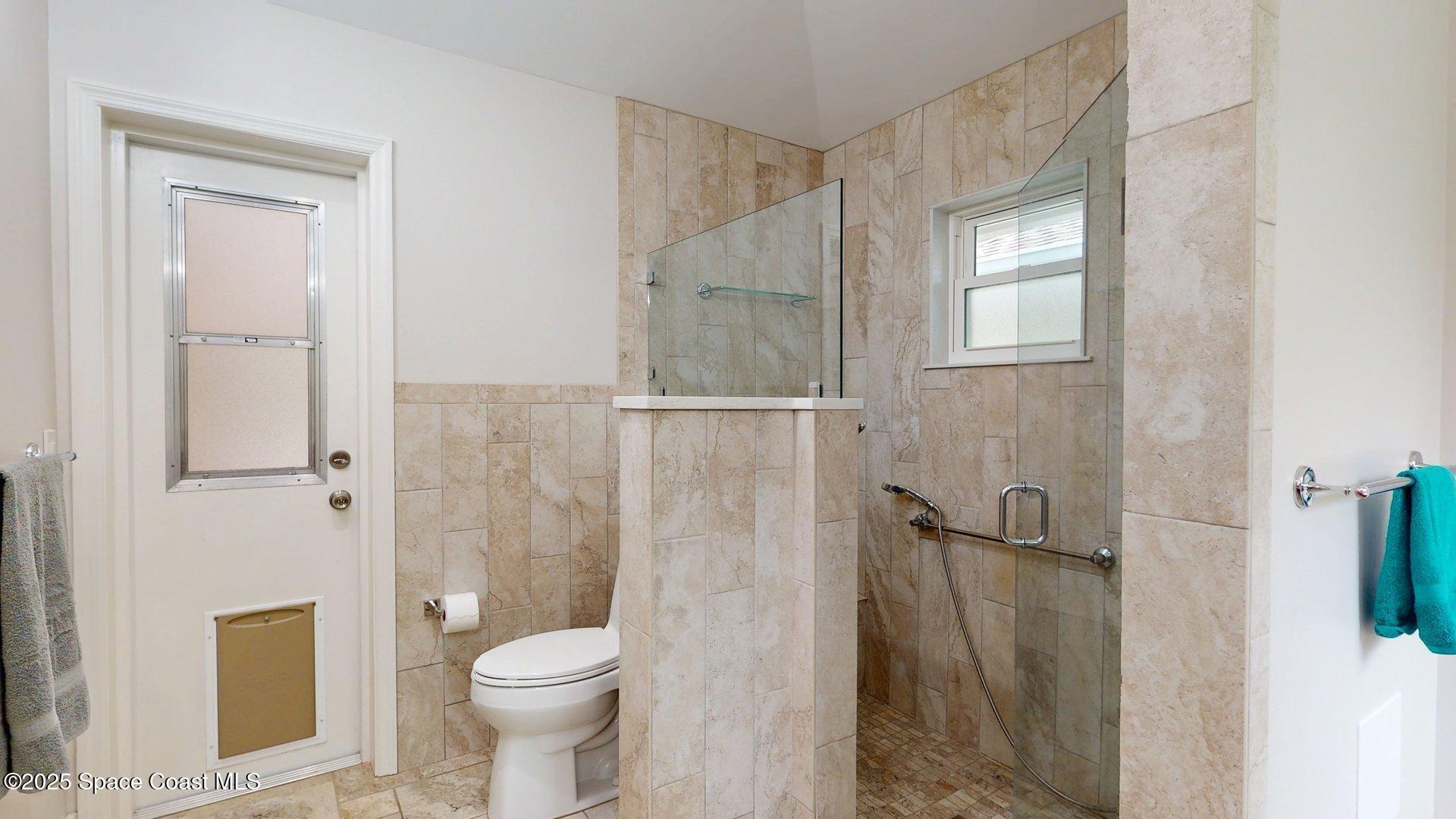 4580 Hunters Run Circle Grant, FL 32949 - Photo 46 of 55 a bathroom with a granite countertop toilet a sink and shower