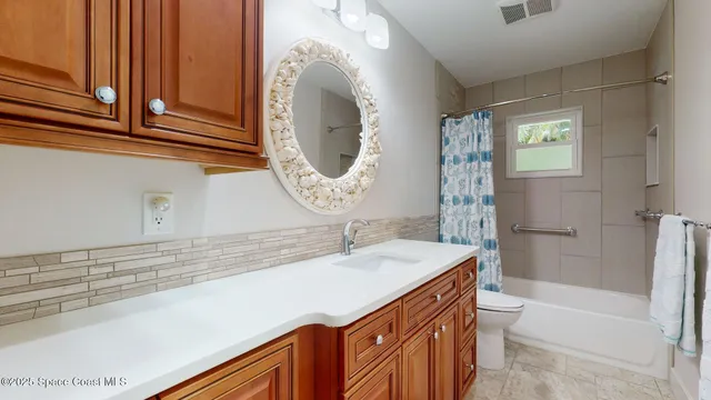 a view of a room with furniture and floor to ceiling windows