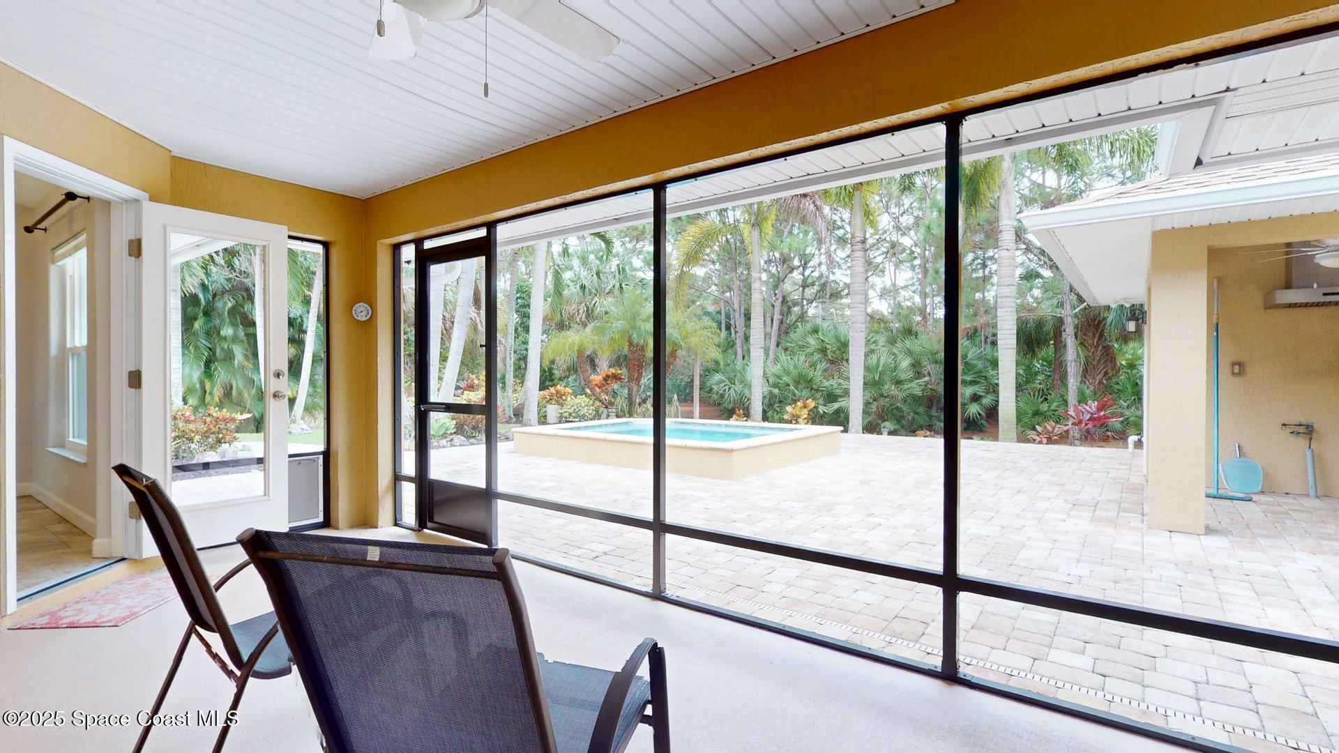 4580 Hunters Run Circle Grant, FL 32949 - Photo 52 of 55 a view of a room with furniture and floor to ceiling windows