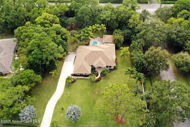 a view of a house with a lot of flower plants