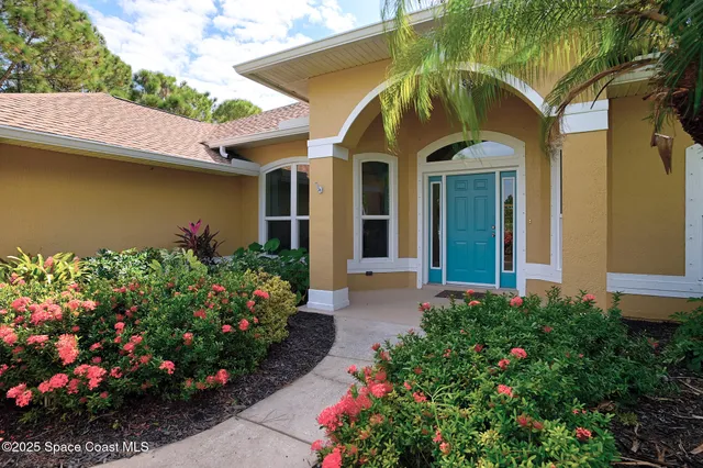 a front view of house with yard and outdoor seating