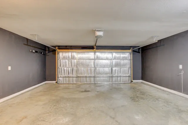 an empty room with closet and a chandelier fan
