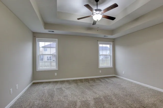a bathroom with a granite countertop sink a toilet and a mirror