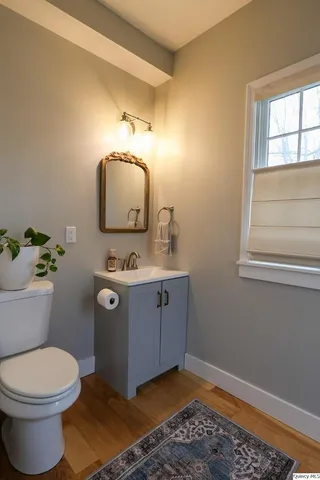 a bathroom with a toilet sink and mirror