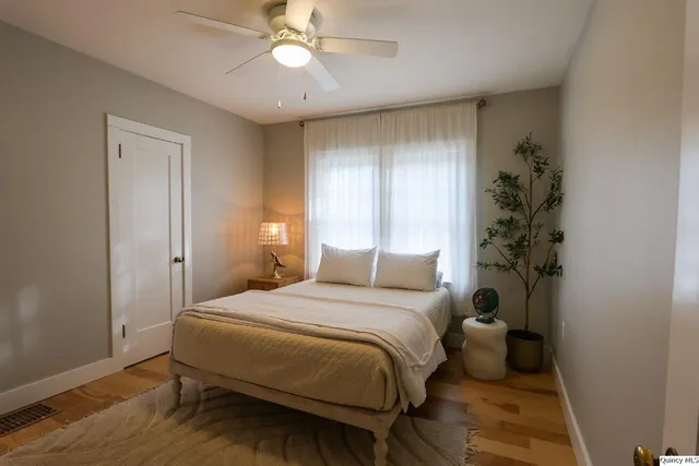 a bedroom with a bed and a chandelier