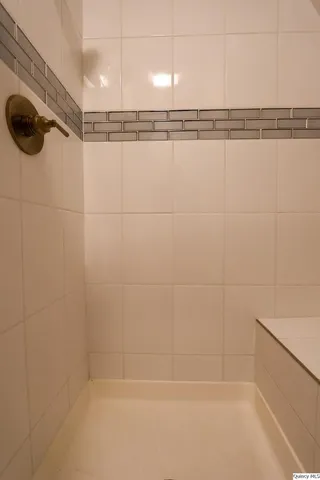 a bathroom with a shower and a shower