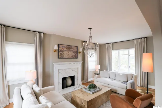 a living room with furniture and a fireplace