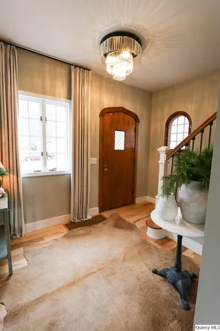 a view of a livingroom with a fireplace and dining area