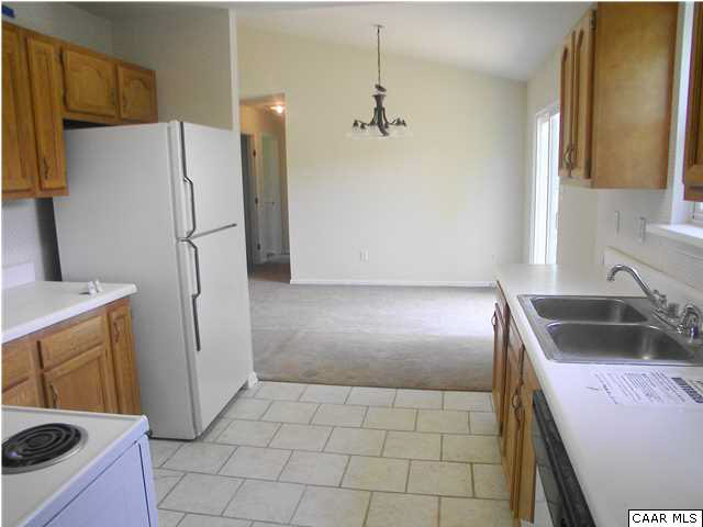 609 East Daffodil Road Ruckersville, VA 22968 - Photo 4 of 12 a kitchen with granite countertop a refrigerator and a sink