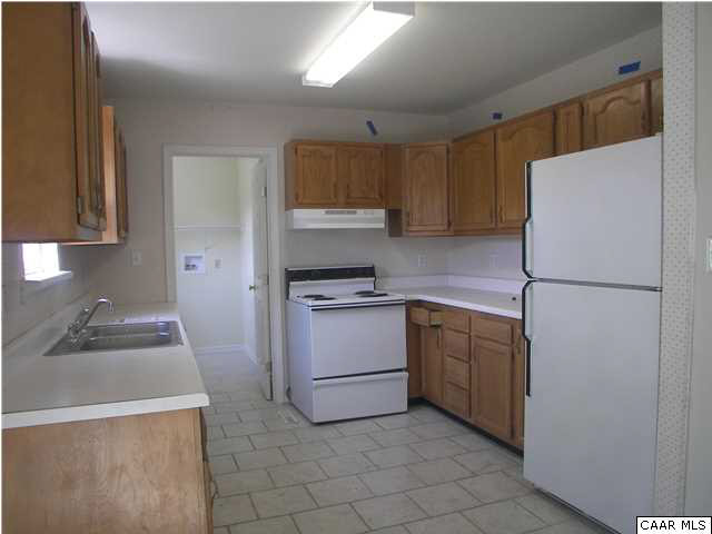 609 East Daffodil Road Ruckersville, VA 22968 - Photo 10 of 12 a kitchen with a refrigerator sink and cabinets