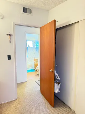 a bedroom with a bed and a mirror
