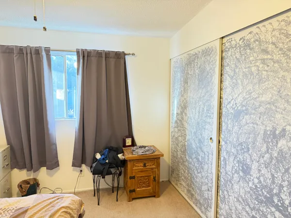 a bed sitting in a bedroom next to a window