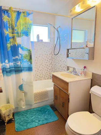 a bedroom with a bed and a white cabinet