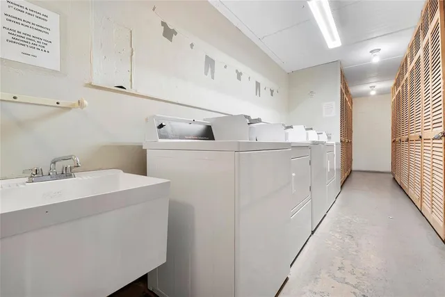 a utility room with cabinets washer and dryer
