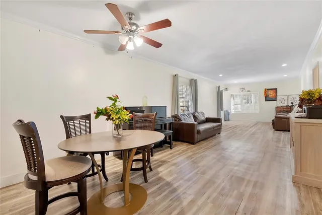 a view of a dining room with furniture and a chandelier