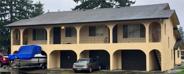 a couple of cars parked in front of a house