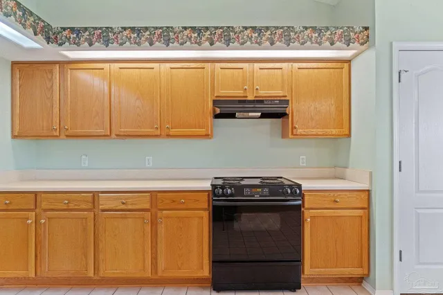 a kitchen with granite countertop cabinets and black appliances