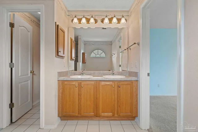 a bathroom with a granite countertop sink a mirror and a vanity