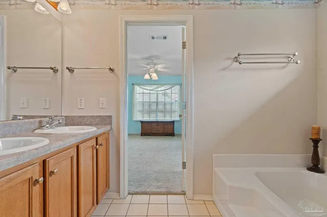 a bathroom with a granite countertop sink a toilet and shower