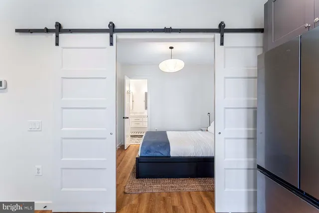 a bedroom with a bed and a night stand