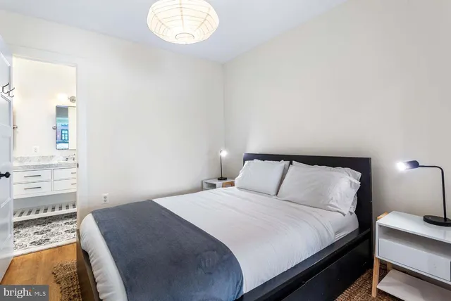 a bedroom with a bed and a night stand