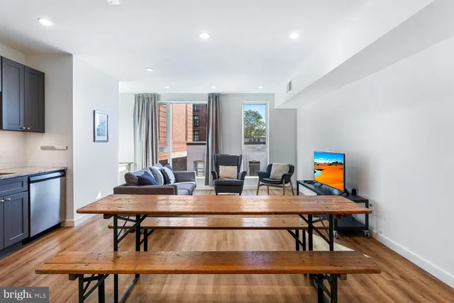 a kitchen with granite countertop a refrigerator and a stove top oven