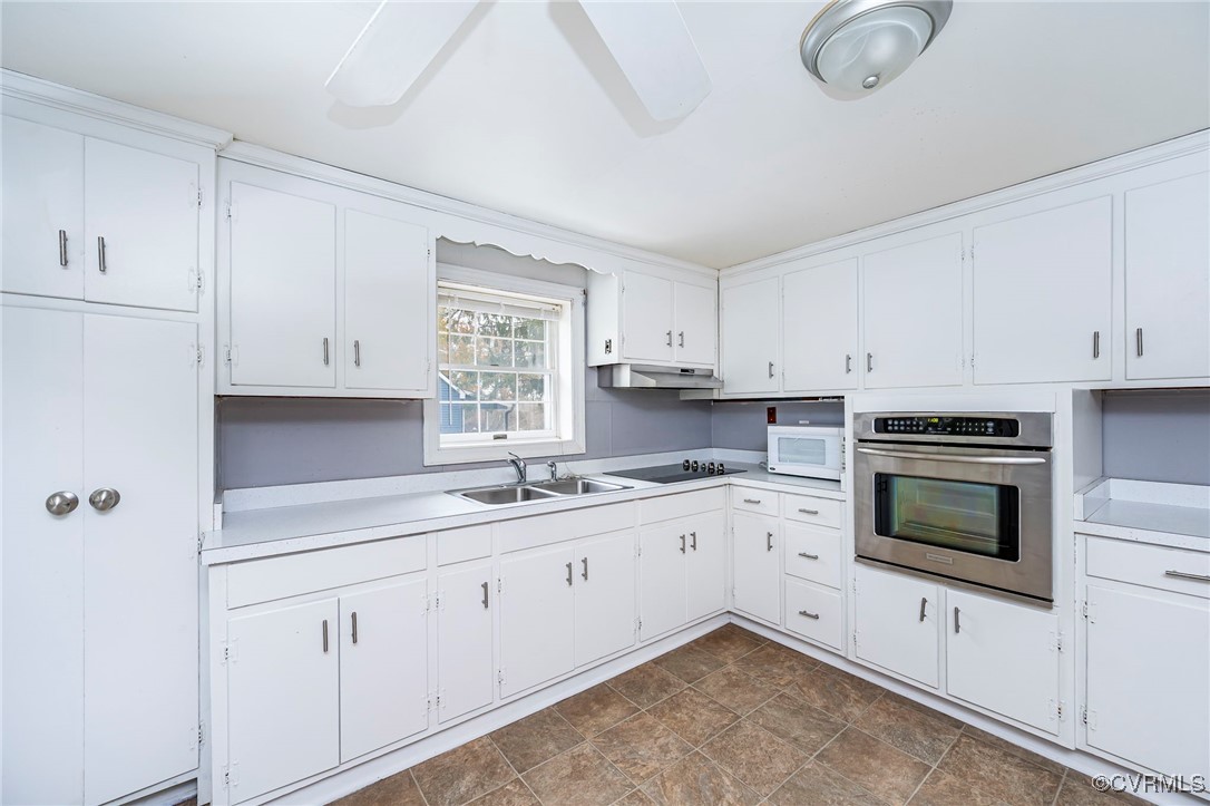 2100 Mt Landing Road Tappahannock, VA 22560 - Photo 14 of 31 Kitchen featuring white cabinets, oven, ceiling fa