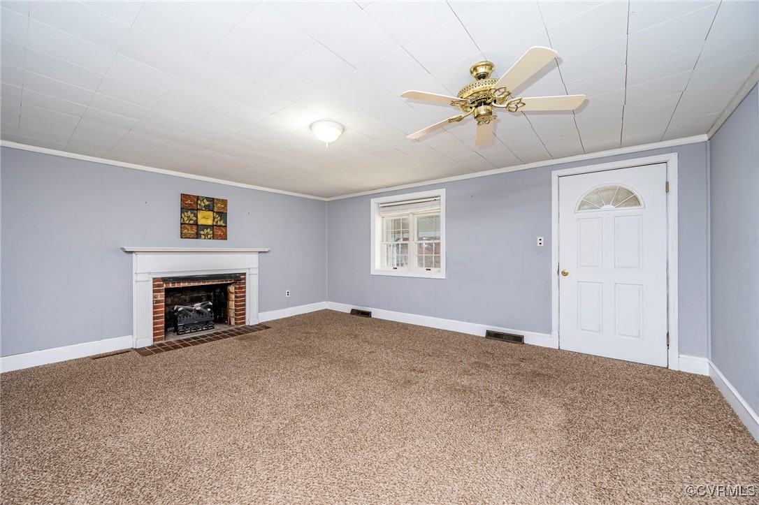 Unfurnished living room with carpet floors and orn