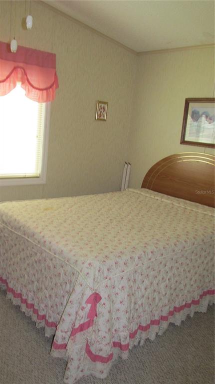 253 Ramsgate Way Haines City, FL 33844 - Photo 16 of 21 a bedroom with a bed and a dresser